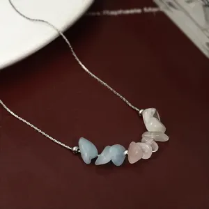 Close-up of handmade raw kyanite and rose quartz stone necklace on a fine silver chain