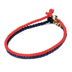 Detailed close-up of handmade braided red and navy blue rope bracelets with knot detail.