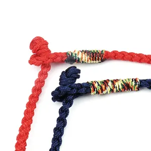 Macro detail view of handmade braided rope bracelets available in red and navy blue colors