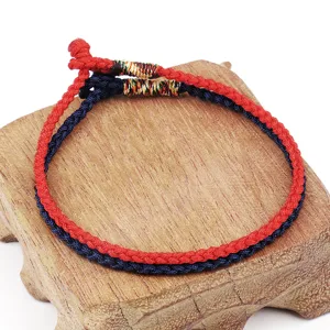 Detailed view of handmade braided rope bracelets in vibrant red and classic navy blue
