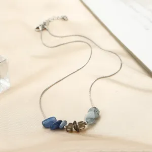 Close-up of original design necklace featuring blue and brown raw natural stones.