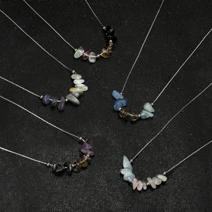Close-up of natural raw stone necklaces with kyanite and amethyst on silver chains