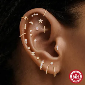 Close-up detail of 925 sterling silver opal earring set with gold plating on ear piercing