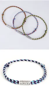 Handmade colorful braided cotton rope bracelet with engraved six-syllable mantra silver bead