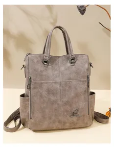 Detailed view of the versatile taupe soft PU leather women backpack with luxury metal kangaroo logo.