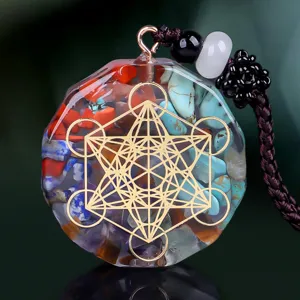 Detailed macro shot of a resin pendant featuring crushed natural crystals and a gold sacred geometry symbol