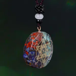 Close-up of a resin pendant necklace featuring multi-colored crystal gravel and gold symbol