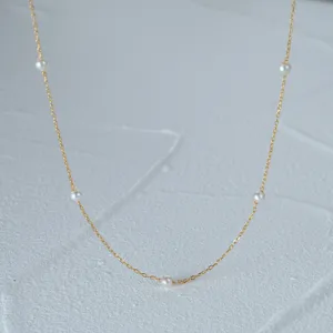 Close-up of 925 sterling silver gold-plated chain with delicate pearls