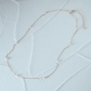 Minimalist 925 sterling silver necklace featuring delicate white pearls on a fine chain.