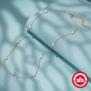 Detail of an exquisite 925 sterling silver necklace with small pearls in minimalist style
