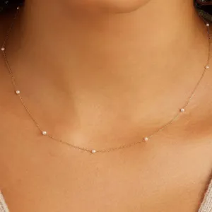 Detailed macro shot of an elegant 925 silver gold-plated pearl necklace on neck