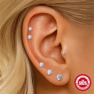 Close-up of 925 sterling silver moissanite stud earrings on ear with six-prong design.