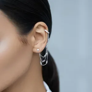 Detailed view of 925 sterling silver tassel chain ear cuff with zircon studs on ear
