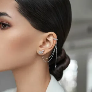 Close-up of 925 sterling silver star earring with tassel and zircon ear cuff