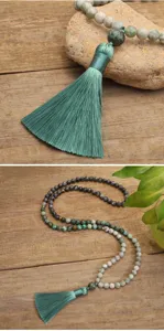 Detailed view of 108 beads African turquoise mala necklace with a long green tassel