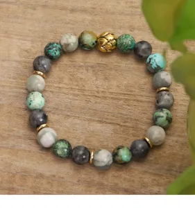 Detailed view of African turquoise and labradorite yoga bracelet with lotus bead