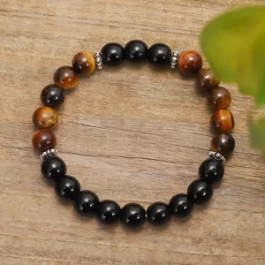 Bracciale elastico fatto a mano con occhio di tigre e ossidiana nera su legno naturale