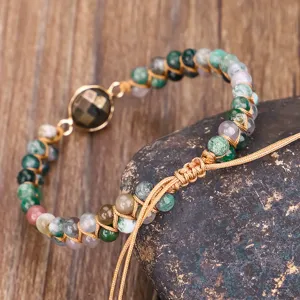 Detail showing the braided double-layer Indian agate bracelet with a faceted stone charm