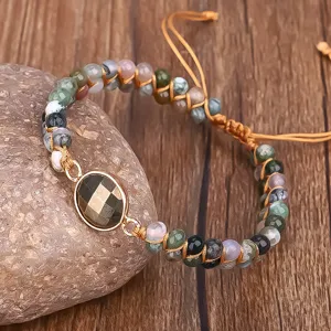 Detailed view of handmade double-layer Indian Agate yoga bracelet on a natural stone