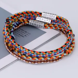 Handmade ethnic style woven cotton rope bracelet with engraved Six Character Mantra beads