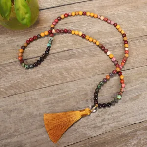 Detail view of a bohemian 108-bead natural stone Mala necklace with golden silk tassel