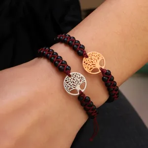 Detailed view of handmade matte stone bead bracelets featuring gold and silver tree of life.