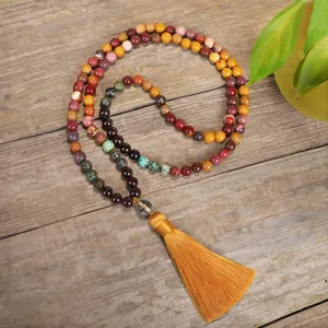 Detailed macro view of 108 stone beads and yellow silk tassel of the Mala necklace