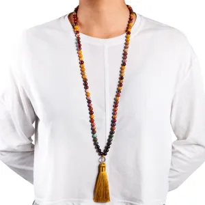 Close-up detail of a 108 natural stone bead necklace featuring a long golden silk tassel