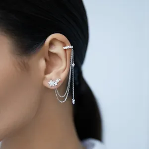 Elegant sterling silver star ear cuff with sparkling zircon tassels on model's ear