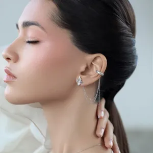 Close-up view of a 925 sterling silver ear cuff earring with chain tassels and zirconia