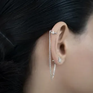 Close-up of a 925 sterling silver ear cuff with tassel chain and sparkling star detail.