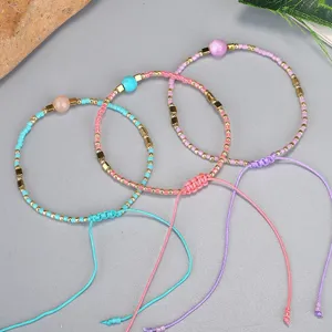 Close-up of three handmade bohemian Miyuki seed bead bracelets with adjustable string cord.