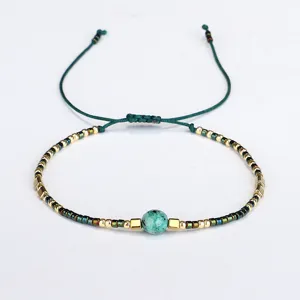 Handmade Bohemian beaded bracelet featuring semi-precious stone and adjustable cord.