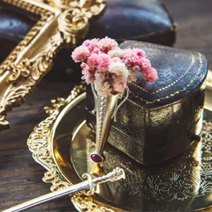 Close-up of vintage S925 sterling silver vase brooch with dried flowers and red gem