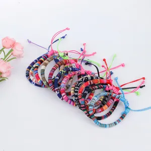 Detail of hand-woven ethnic style cotton rope bracelets with colorful geometric patterns.