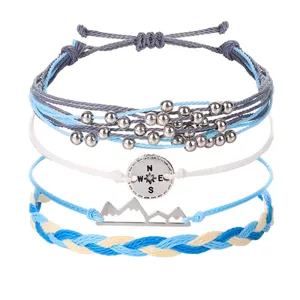 Handgefertigtes Wachsfaden-Armband-Set mit Berg- und Kompassanhängern in Blau und Weiß