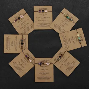 Macro view of assorted hand-woven natural stone beaded wish bracelets on kraft cards