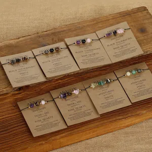 Detail view of handmade woven gemstone wish bracelets on kraft display cards