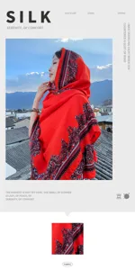 Close-up of the red ethnic silk scarf displaying intricate paisley print and soft smooth fabric.