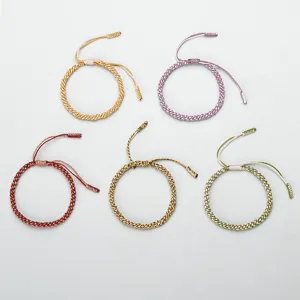Detailed view of five colorful handmade braided cotton bracelets with corn knots