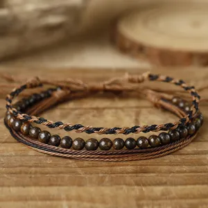 Detailed view of three-piece handmade woven wax thread and beaded friendship bracelet