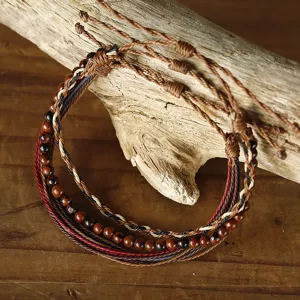 Detailed macro view of 3-piece handmade woven wax cord friendship bracelets with beads