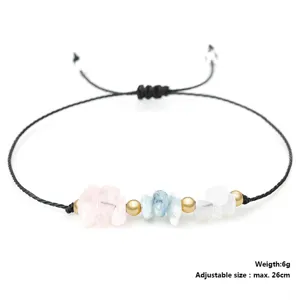 Detail view of adjustable beaded bracelet with pink crystal and aquamarine stones.