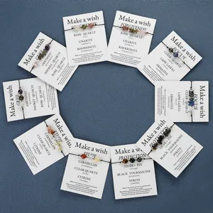 Variety of handmade beaded wish bracelets with natural healing stones on display cards