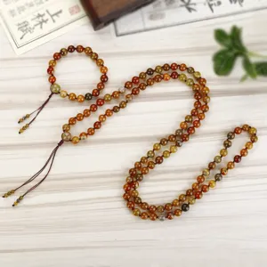 Detail van 108 mala kralen ketting van drakenader agaat met bijpassende armband