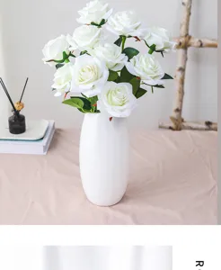 Artificial white rose bouquet in ceramic vase, elegant home decor for wedding and Valentine's Day.