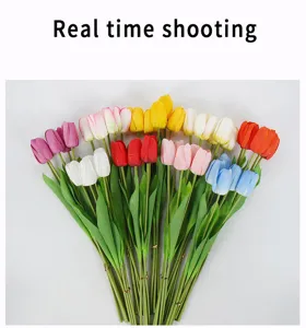 Detail shot of colorful artificial silk tulips bouquets, realistic floral decor props.