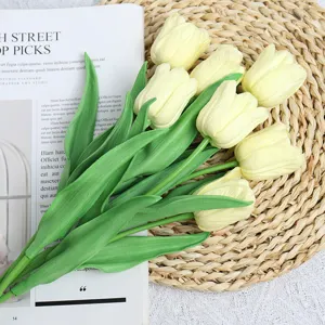 Close-up detail of artificial yellow tulips with green stems, perfect for home decor and photo prop.