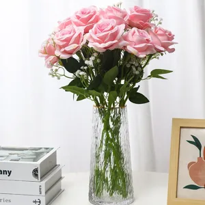 Artificial pink rose bouquet in clear glass vase, perfect for home wedding decor.