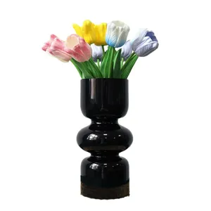 Artificial tulip flower bouquet with modern black vase for home decor and photography.